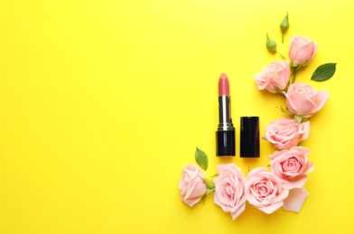 Flat lay composition with lipstick, roses and space for text on color background