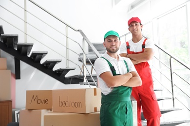 Photo of Portrait of male movers in uniform indoors