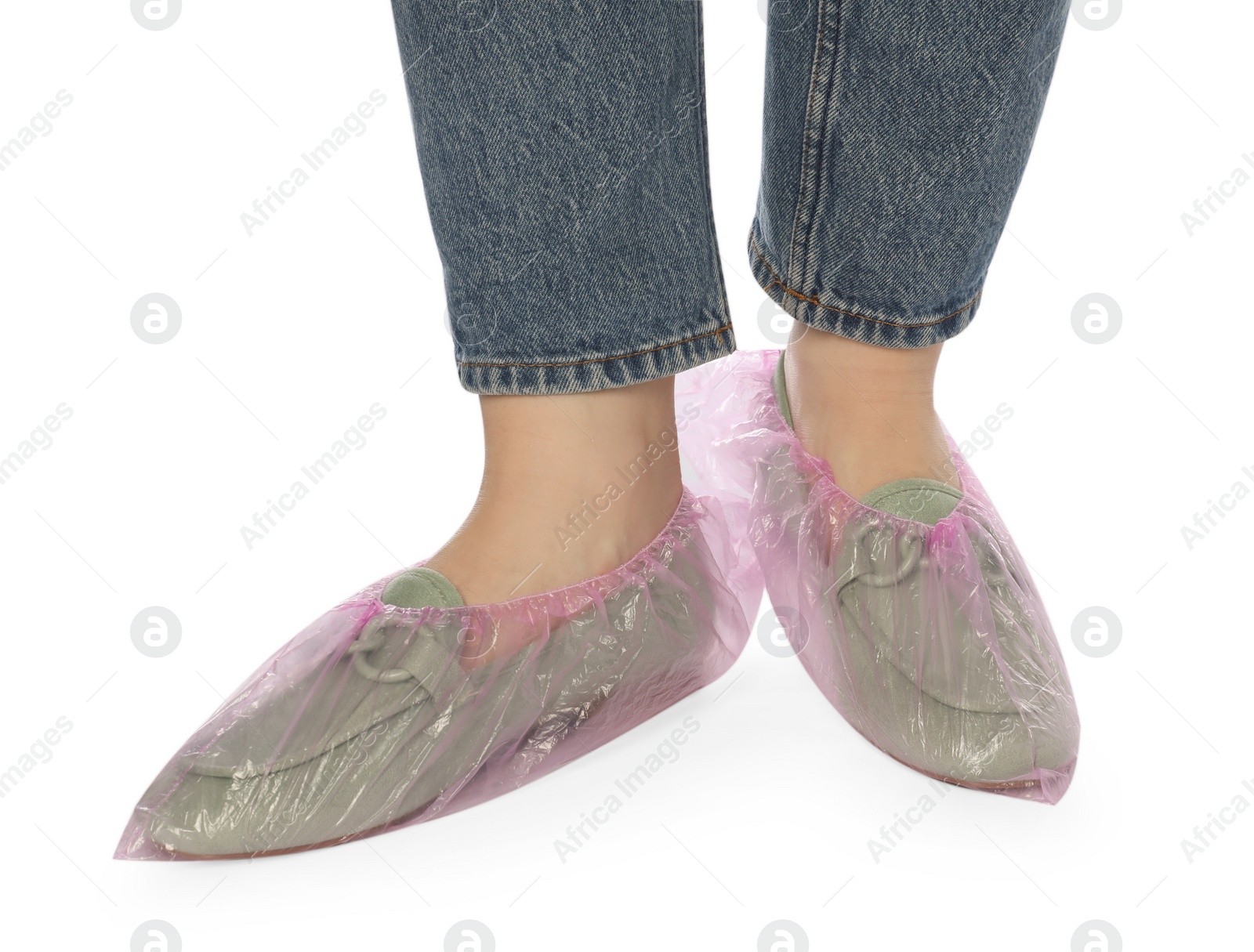 Photo of Woman wearing shoe covers onto her mules against white background, closeup