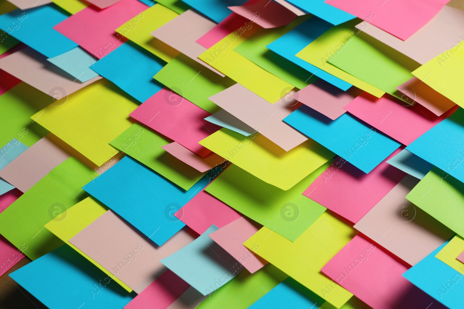 Photo of Colorful paper notes as background, closeup view