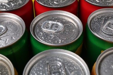 Photo of Energy drinks in wet cans, closeup. Functional beverage