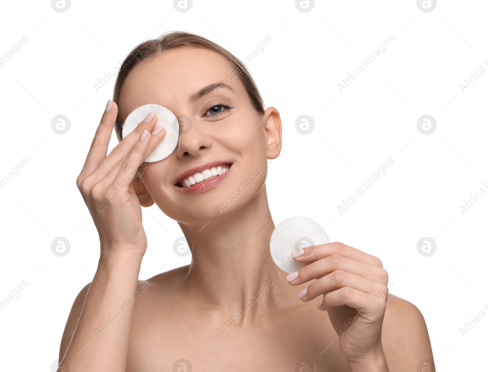 Photo of Smiling woman removing makeup with cotton pads on white background