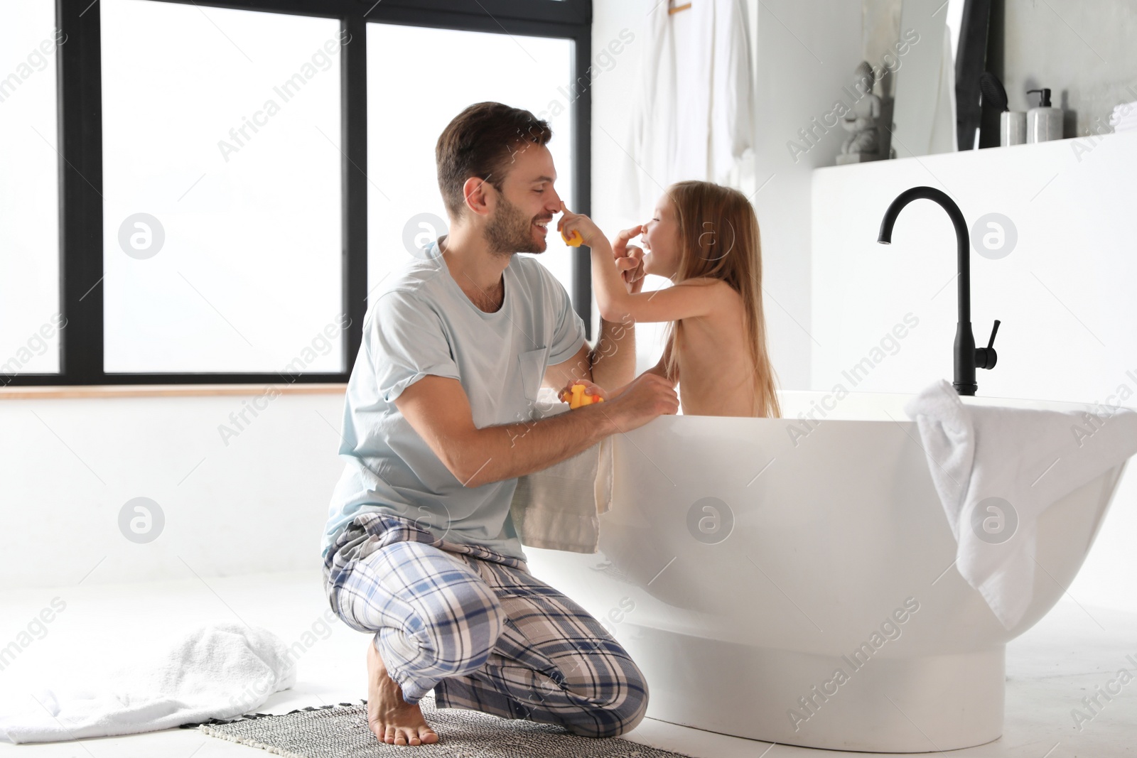 Photo of Father and his cute little daughter in bathroom