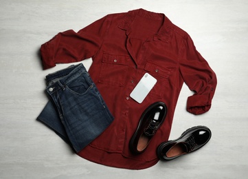 Flat lay composition with stylish female shoes on white table