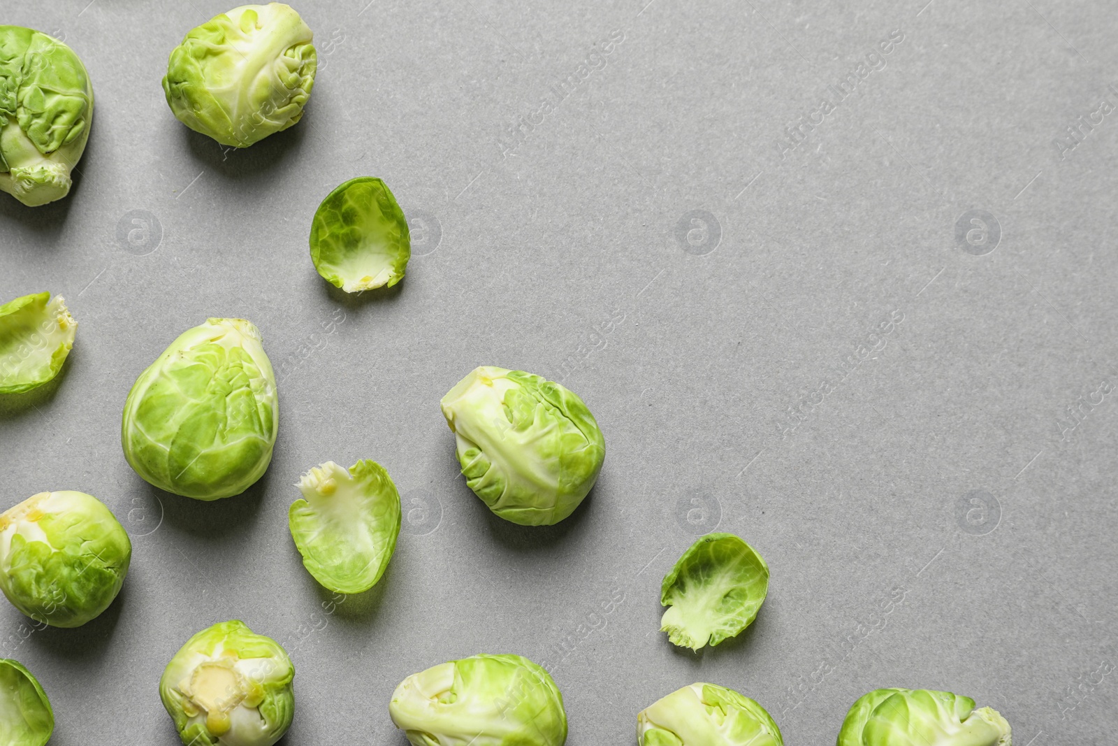 Photo of Tasty fresh Brussels sprouts on grey background, top view with space for text