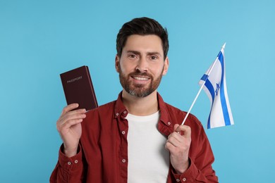 Immigration. Happy man with passport and flag of Israel on light blue background