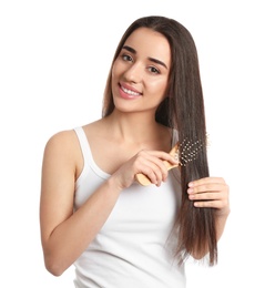 Photo of Beautiful young woman with hair brush on white background