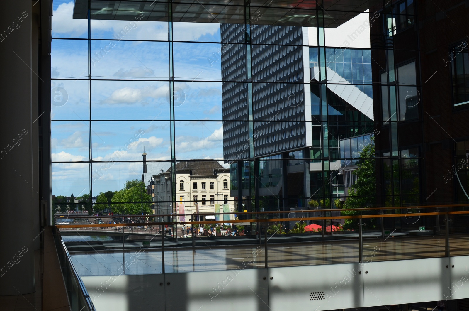 Photo of Beautiful city street with buildings, view through big glass windows