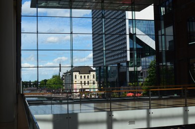 Beautiful city street with buildings, view through big glass windows