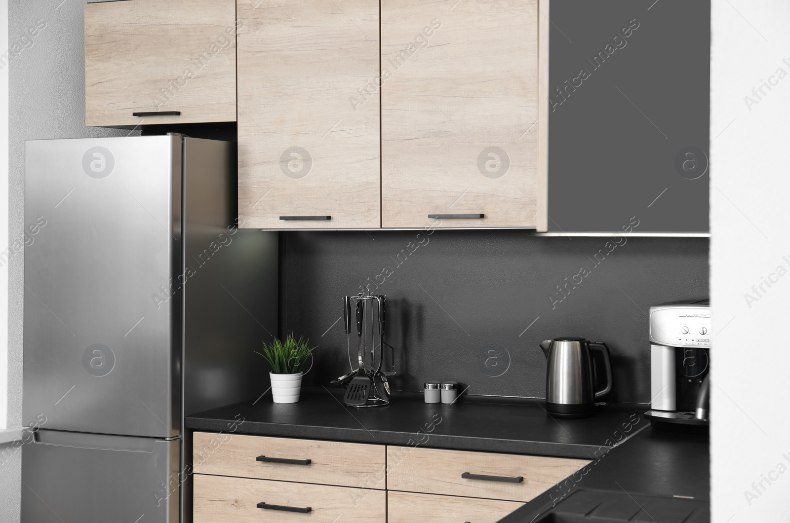 Photo of Cozy modern kitchen interior with new furniture and appliances