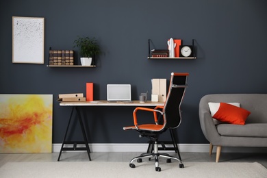 Modern workplace with comfortable chair in stylish home office interior