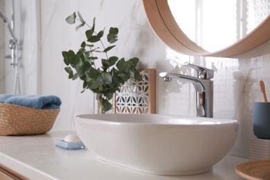 Stylish bathroom interior with vessel sink and decor elements