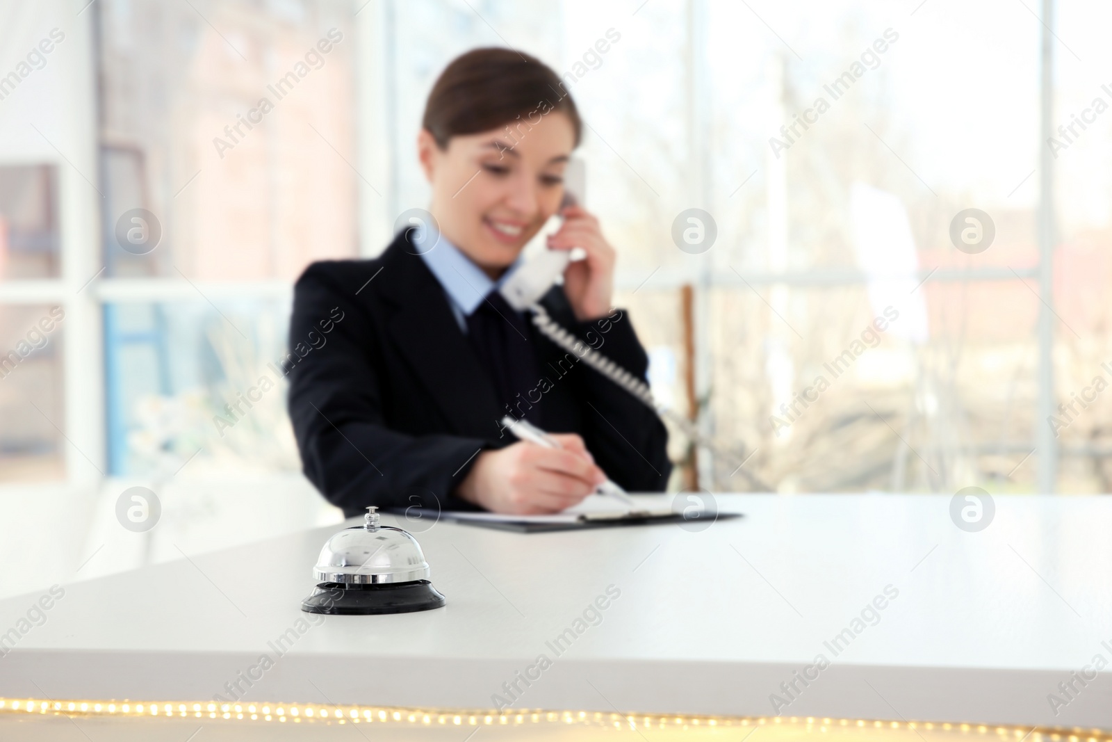 Photo of Service bell and female receptionist in hotel