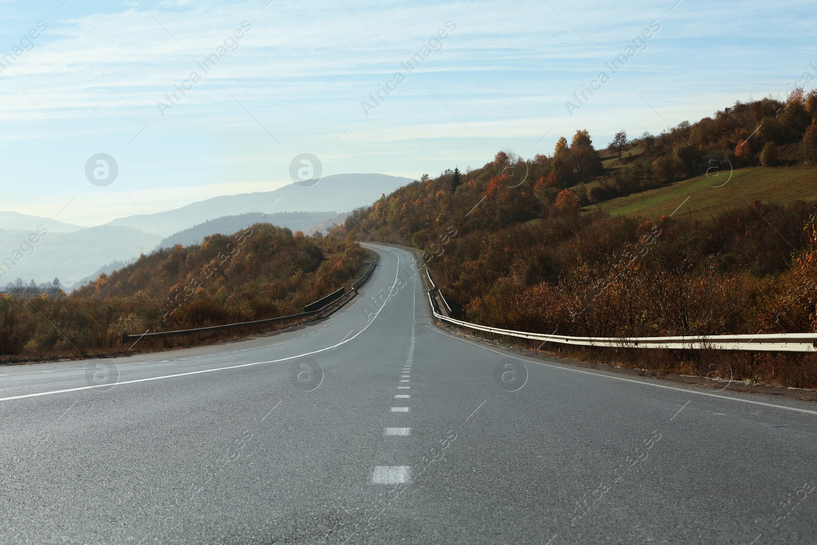 Photo of Landscape with asphalt road leading to mountains