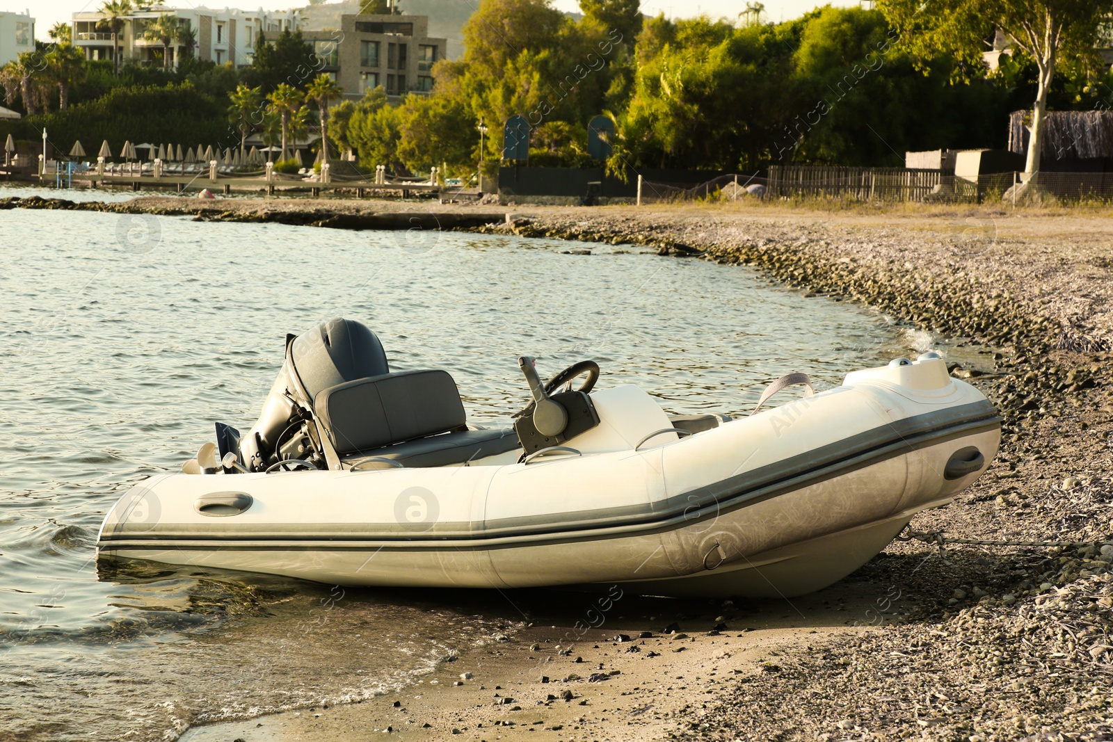 Photo of Beautiful view of resort and moored boat on seashore