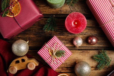 Photo of Flat lay composition with beautifully wrapped gift boxes on wooden table