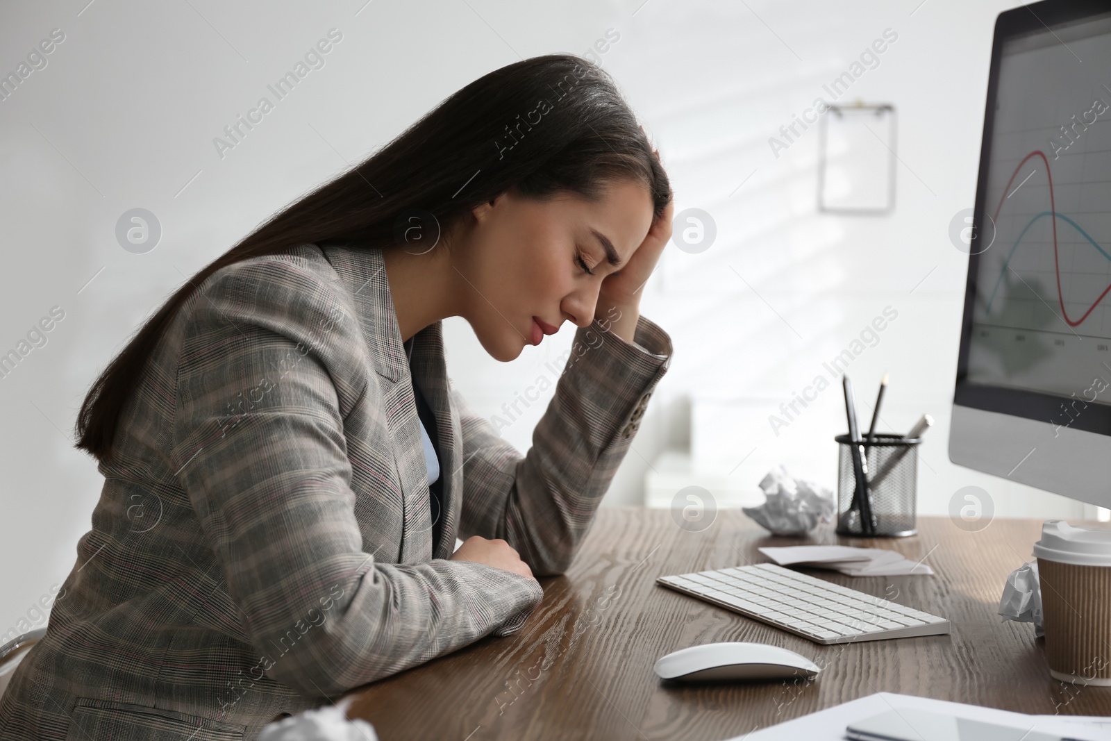 Photo of Businesswoman stressing out at workplace in office