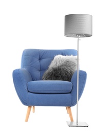 Photo of Comfortable armchair with pillow and lamp on white background