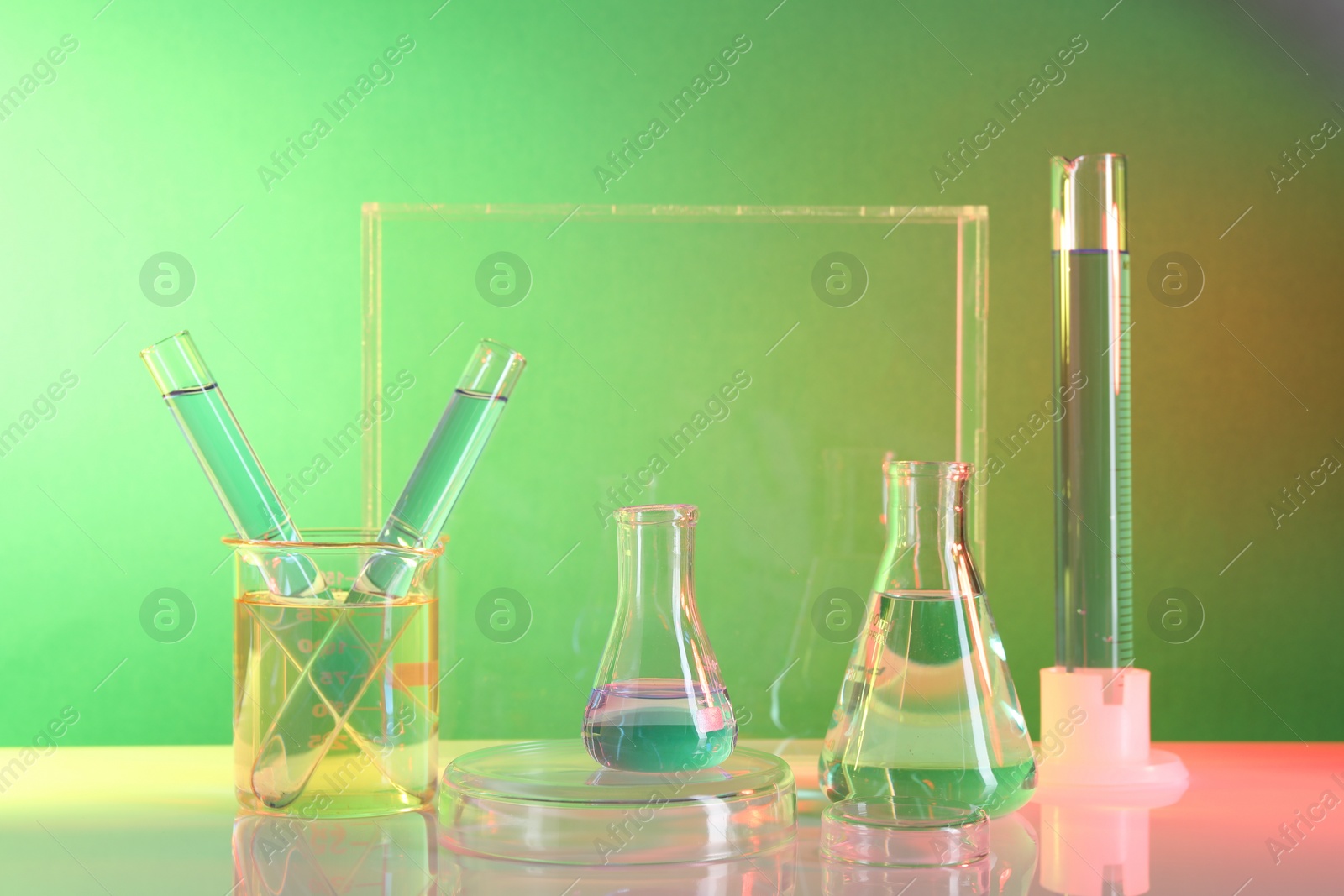 Photo of Laboratory analysis. Different glassware on table against color background