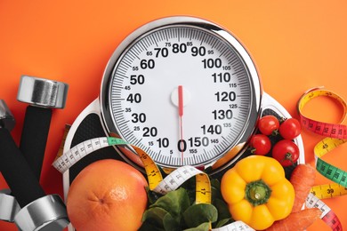 Photo of Flat lay composition with scales and healthy food on orange background