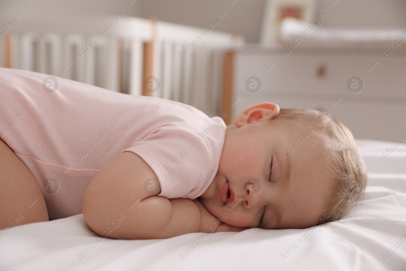Photo of Adorable little baby sleeping on bed at home