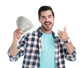 Handsome young man with dollars on white background