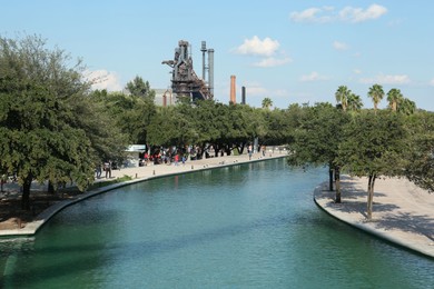 Photo of Monterrey, Mexico - September 11, 2022. Beautiful view of canal and green trees in Parque Fundidora