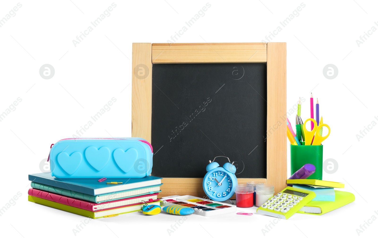 Photo of Different school stationery and small blank chalkboard on white background. Space for text