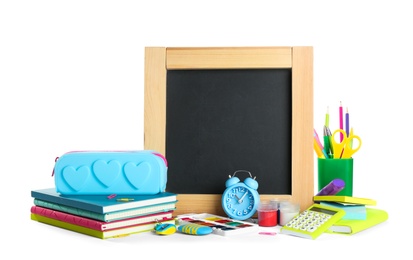 Photo of Different school stationery and small blank chalkboard on white background. Space for text