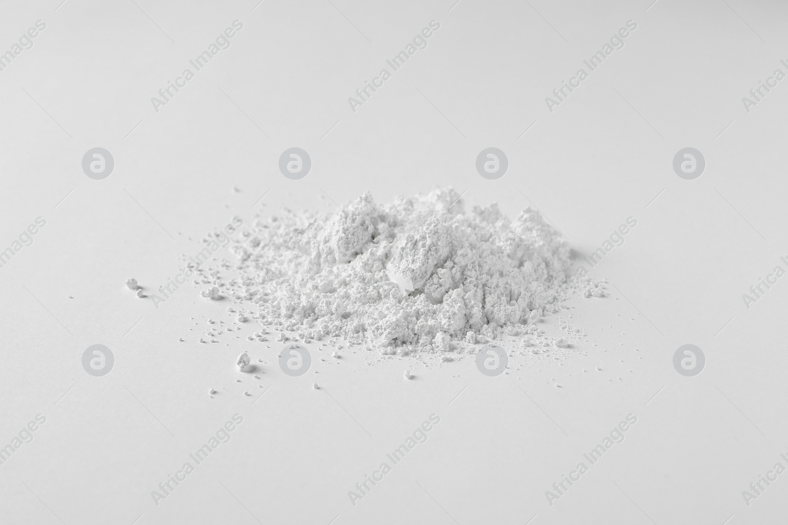 Photo of Heap of calcium carbonate powder on white background