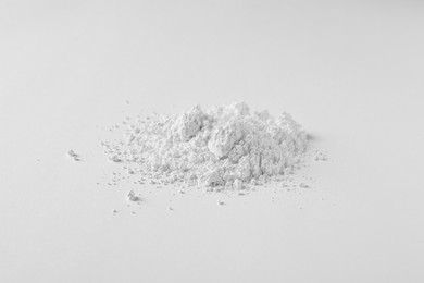 Photo of Heap of calcium carbonate powder on white background