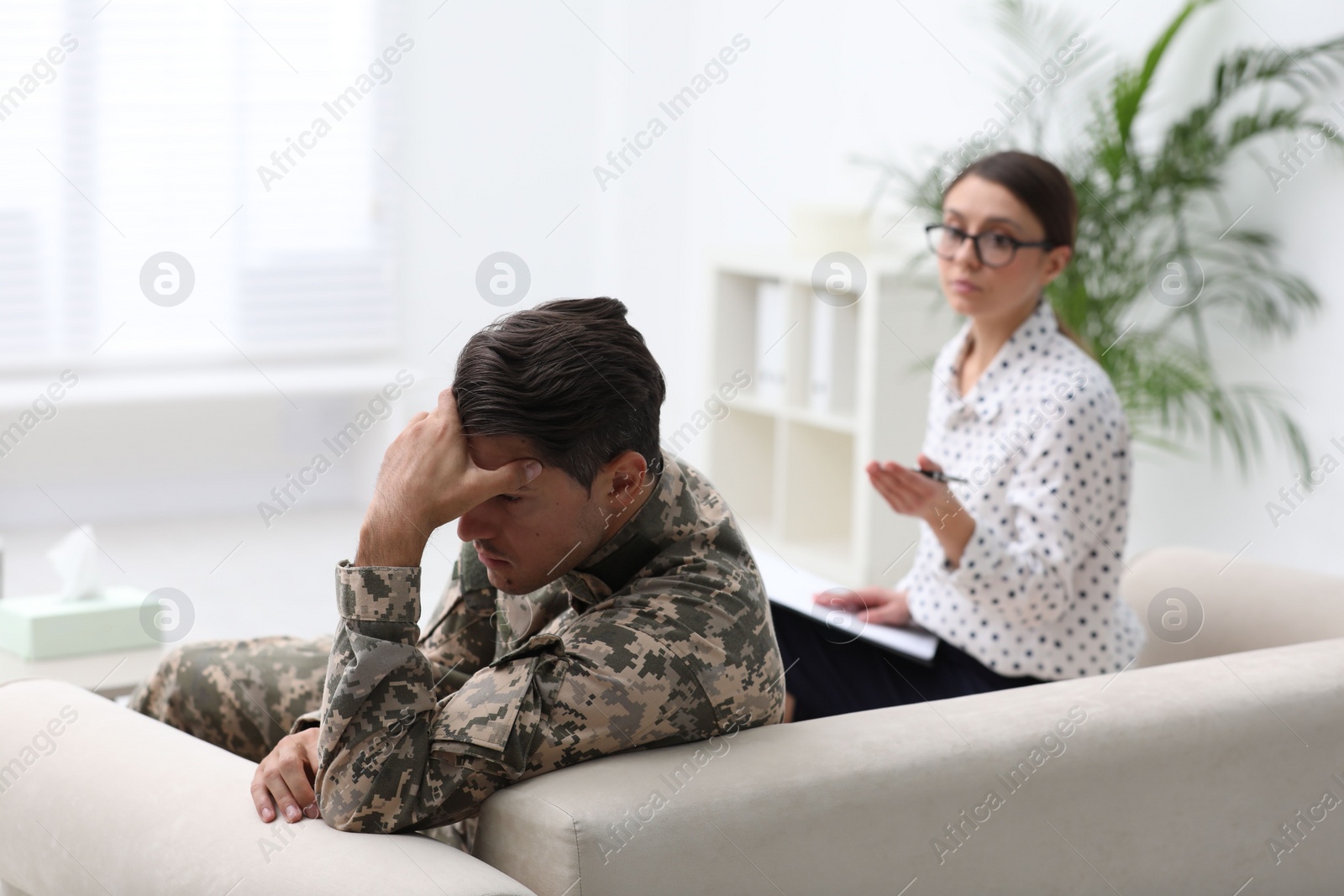 Photo of Psychotherapist working with male military officer in office