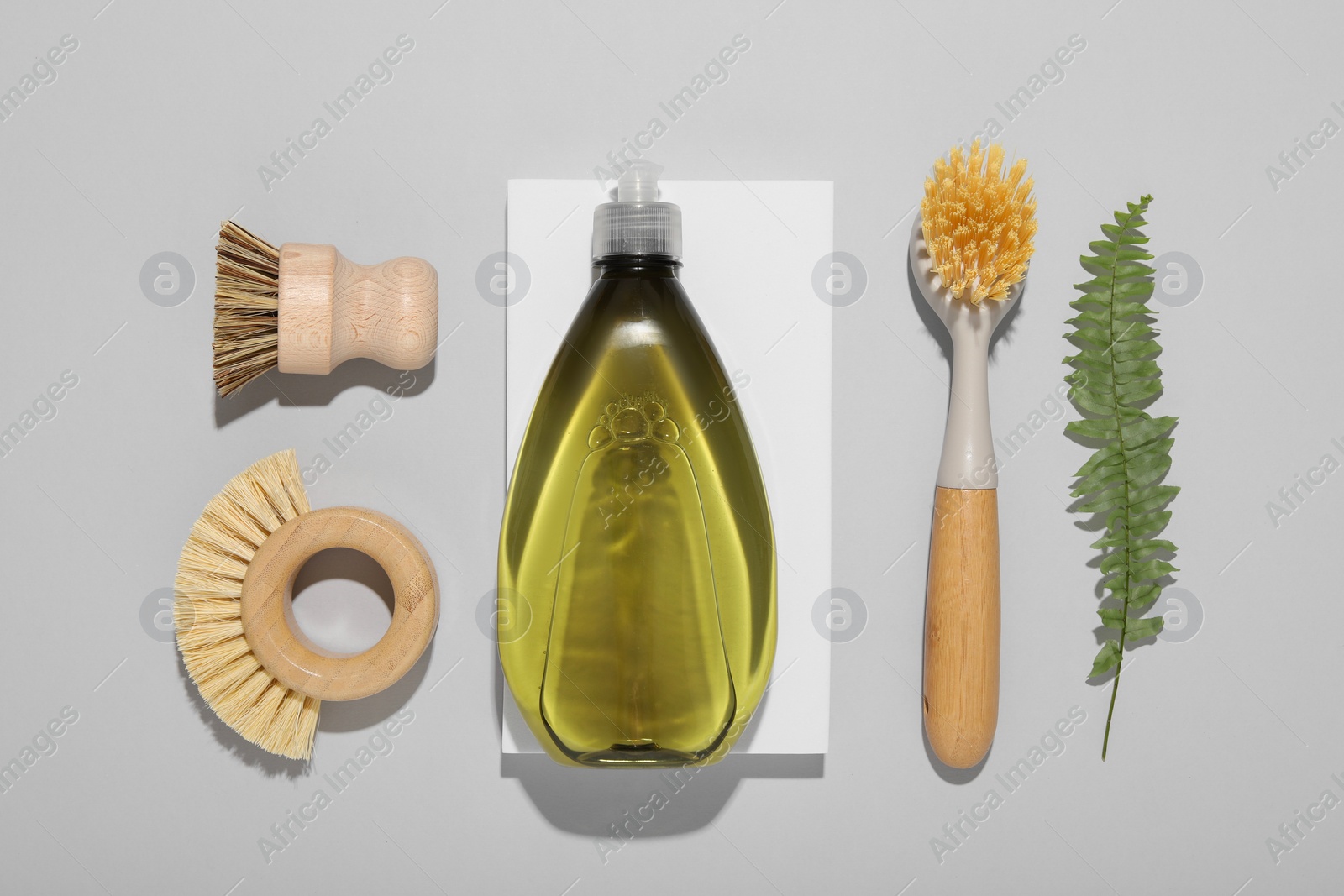 Photo of Flat lay composition with different cleaning supplies on light gray background