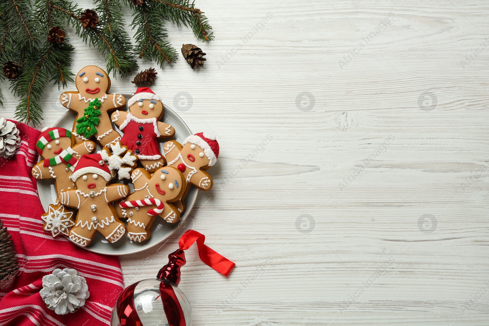 Photo of Delicious Christmas cookies and festive decor on white wooden table, flat lay. Space for text