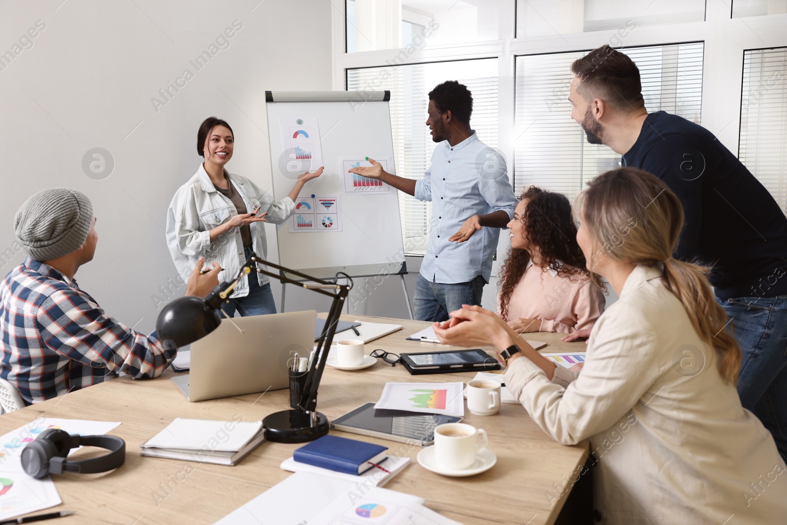 Photo of Team of employees working together in office. Startup project