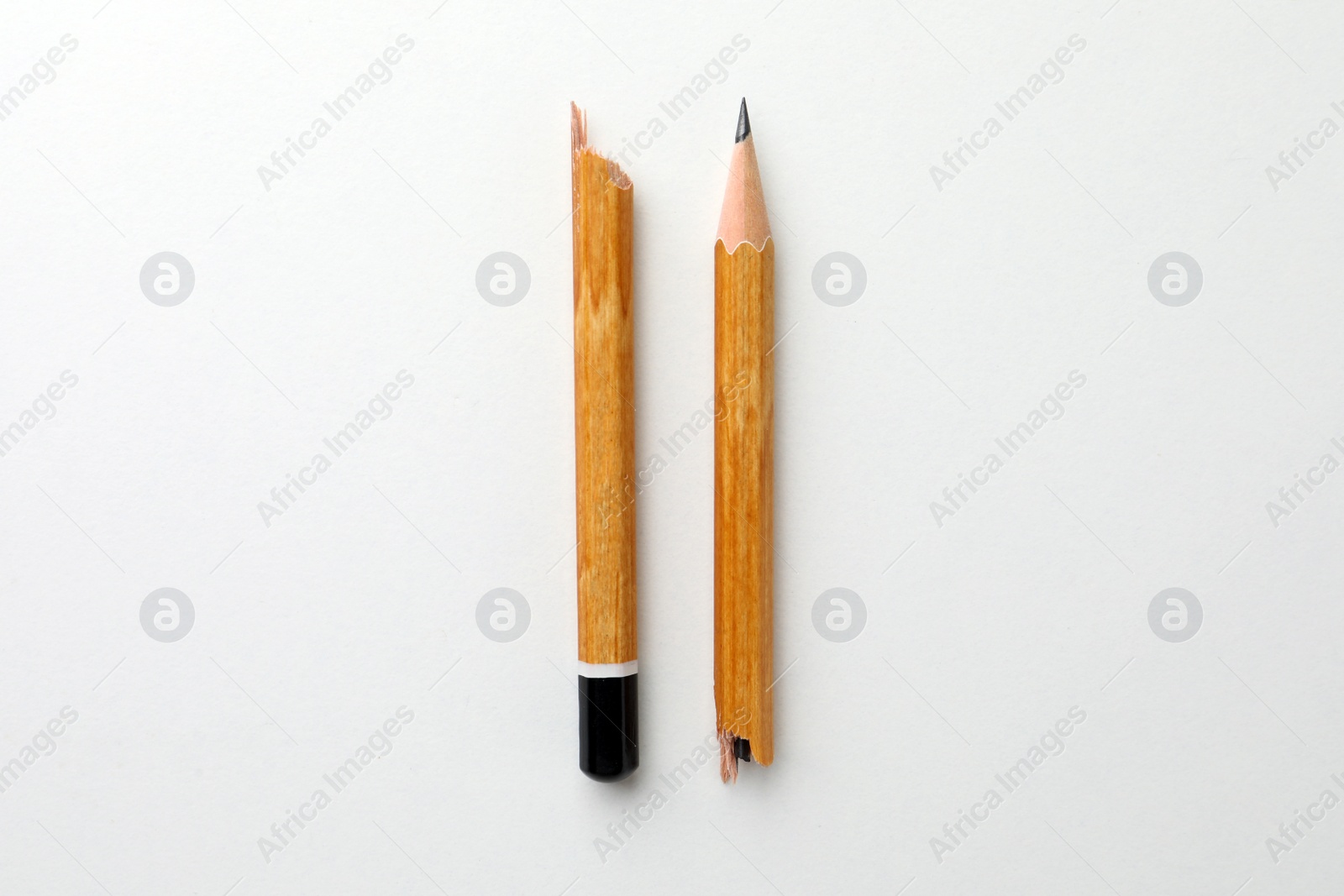 Photo of Broken pencil on white background, flat lay. Pause concept