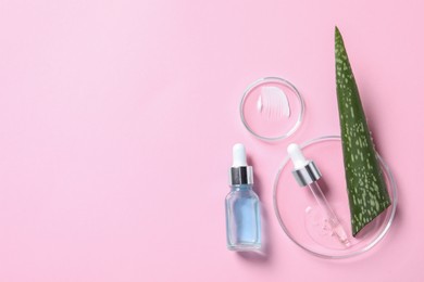 Photo of Bottle of cosmetic serum, aloe vera leaf and petri dishes with samples on pink background, flat lay. Space for text