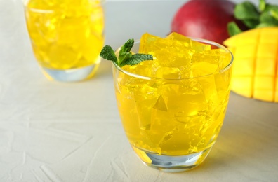 Photo of Composition with mango jelly in glass on  table. Space for text