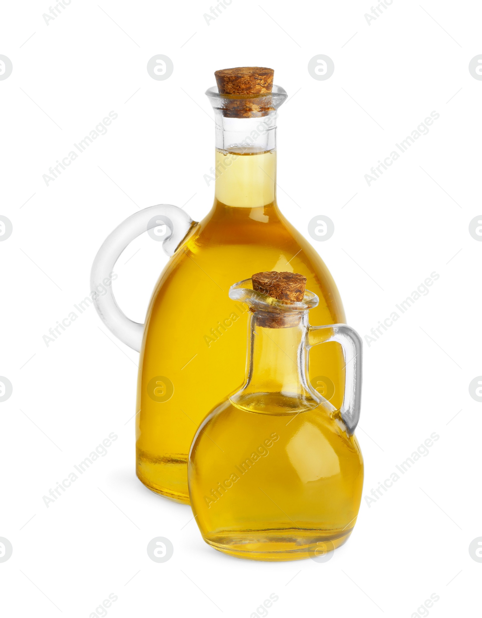 Photo of Glass jugs of cooking oil on white background