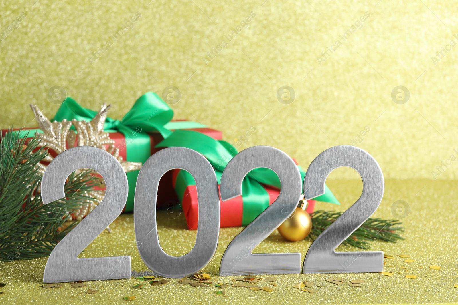 Photo of Silver number 2022 and festive decor on bright background. Happy New Year