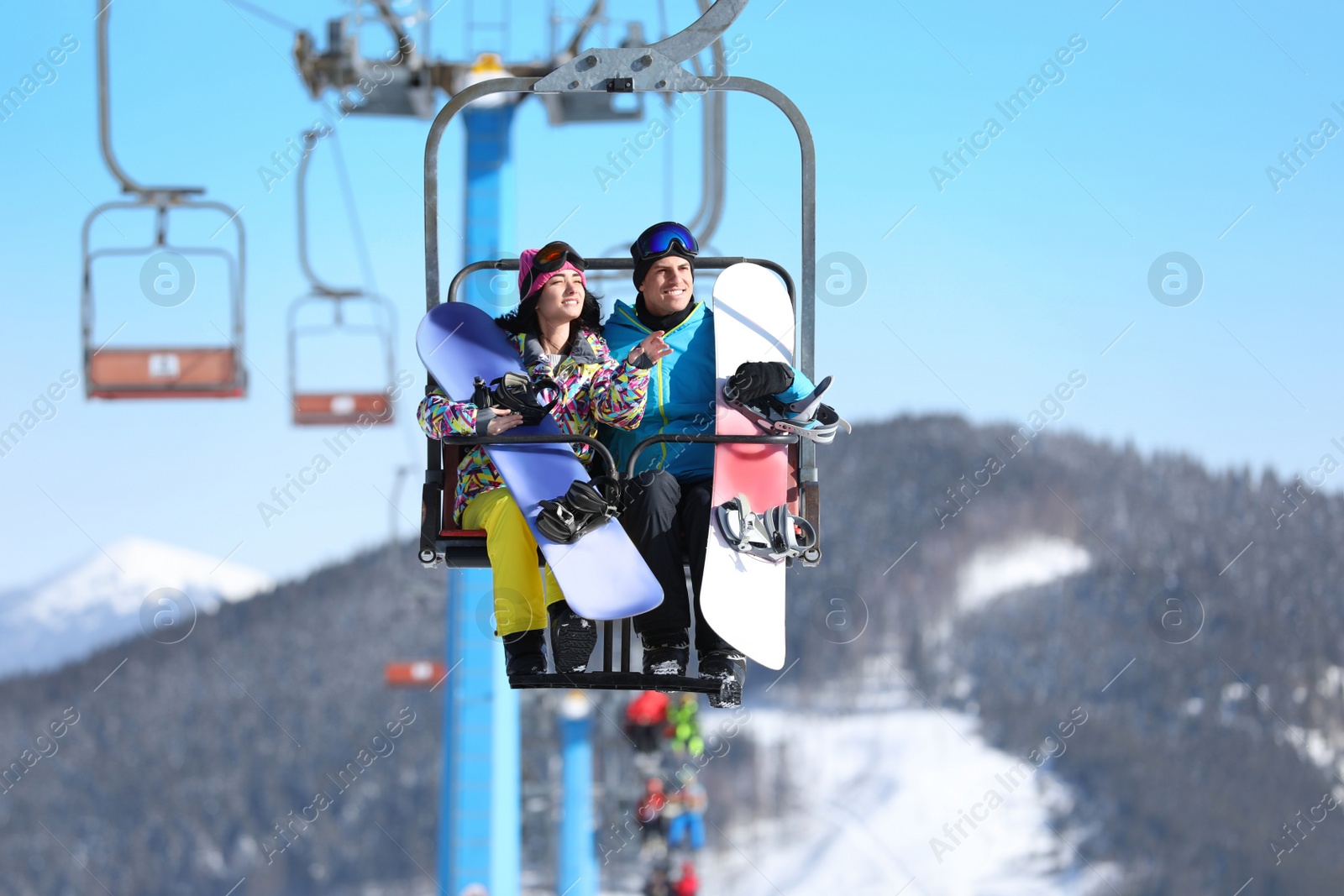 Photo of People using chairlift at mountain ski resort. Winter vacation