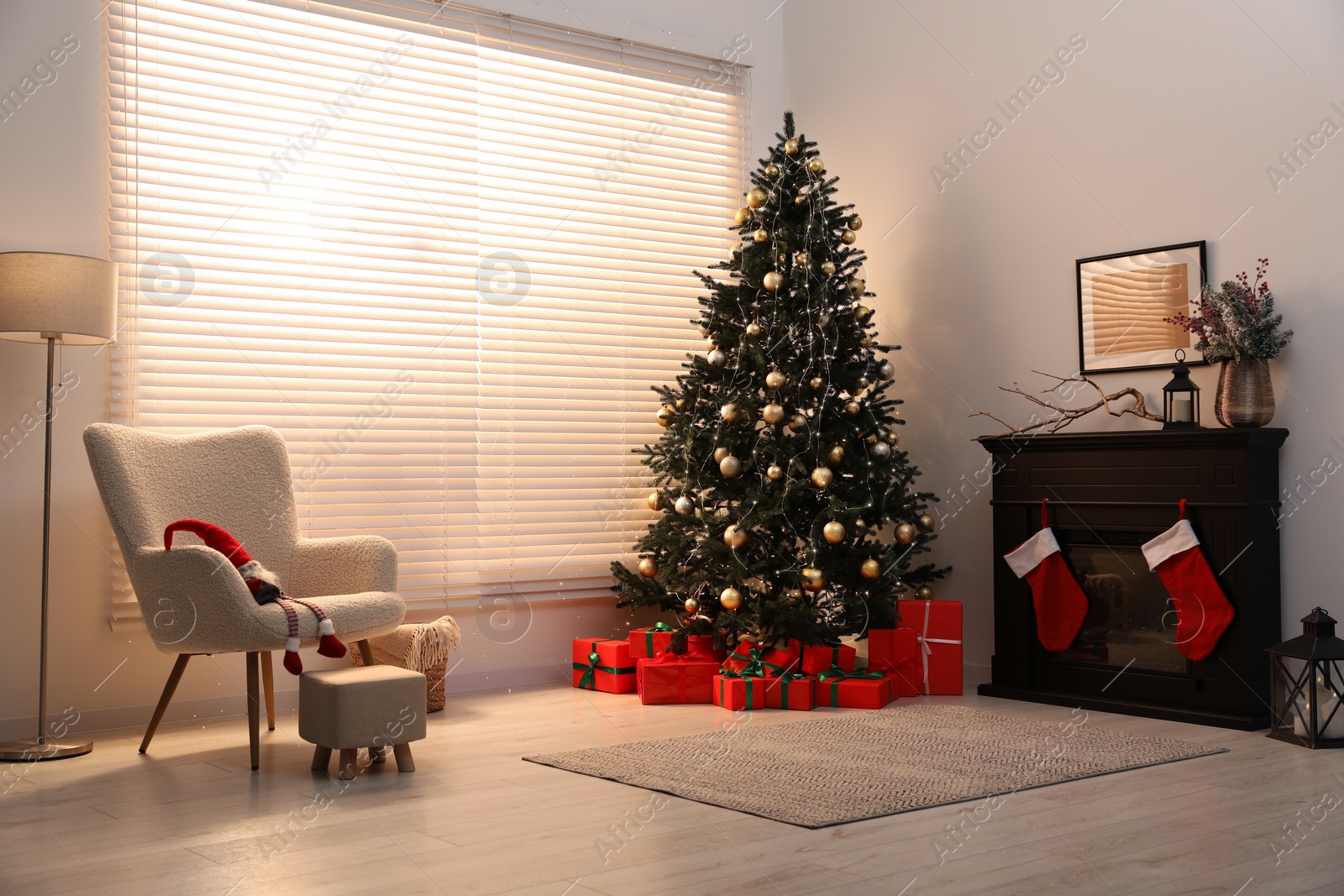 Photo of Beautifully wrapped gift boxes under Christmas tree in living room