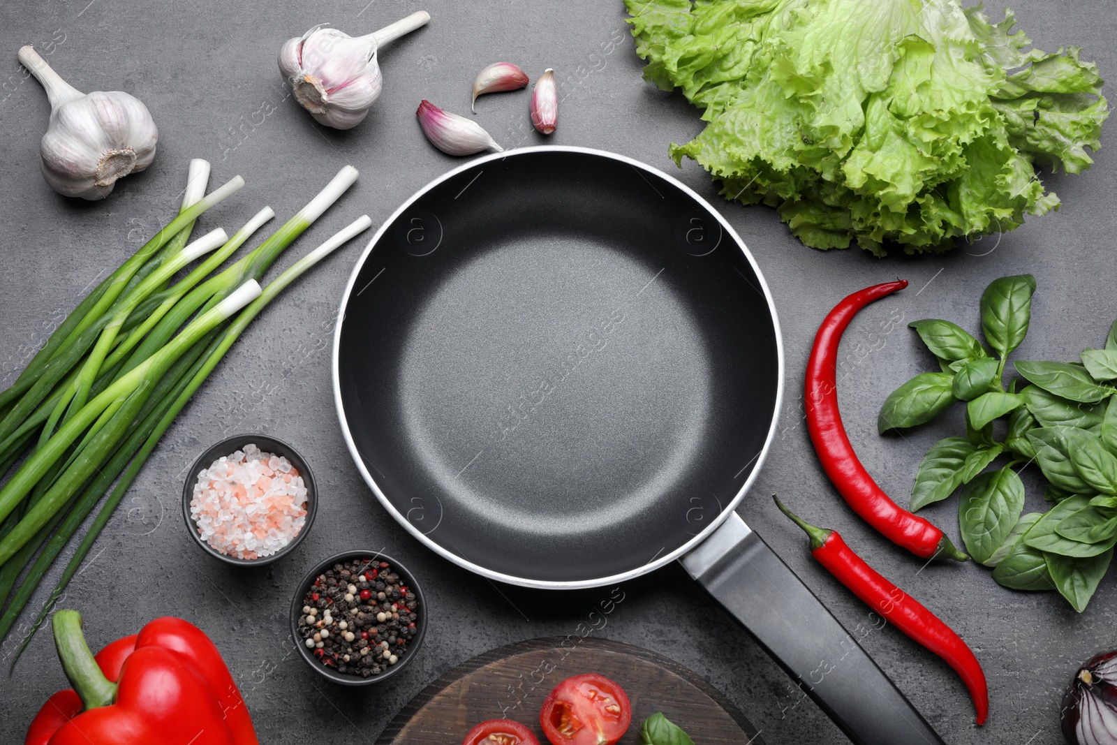 Photo of Flat lay composition with frying pan and fresh products on grey table