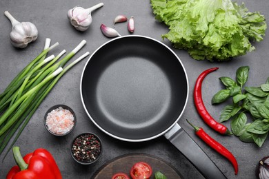 Photo of Flat lay composition with frying pan and fresh products on grey table