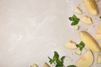 Photo of Flat lay composition with cut tasty melon on table. Space for text