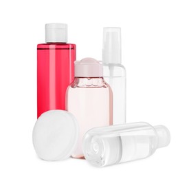 Photo of Bottles of micellar cleansing water and cotton pads on white background