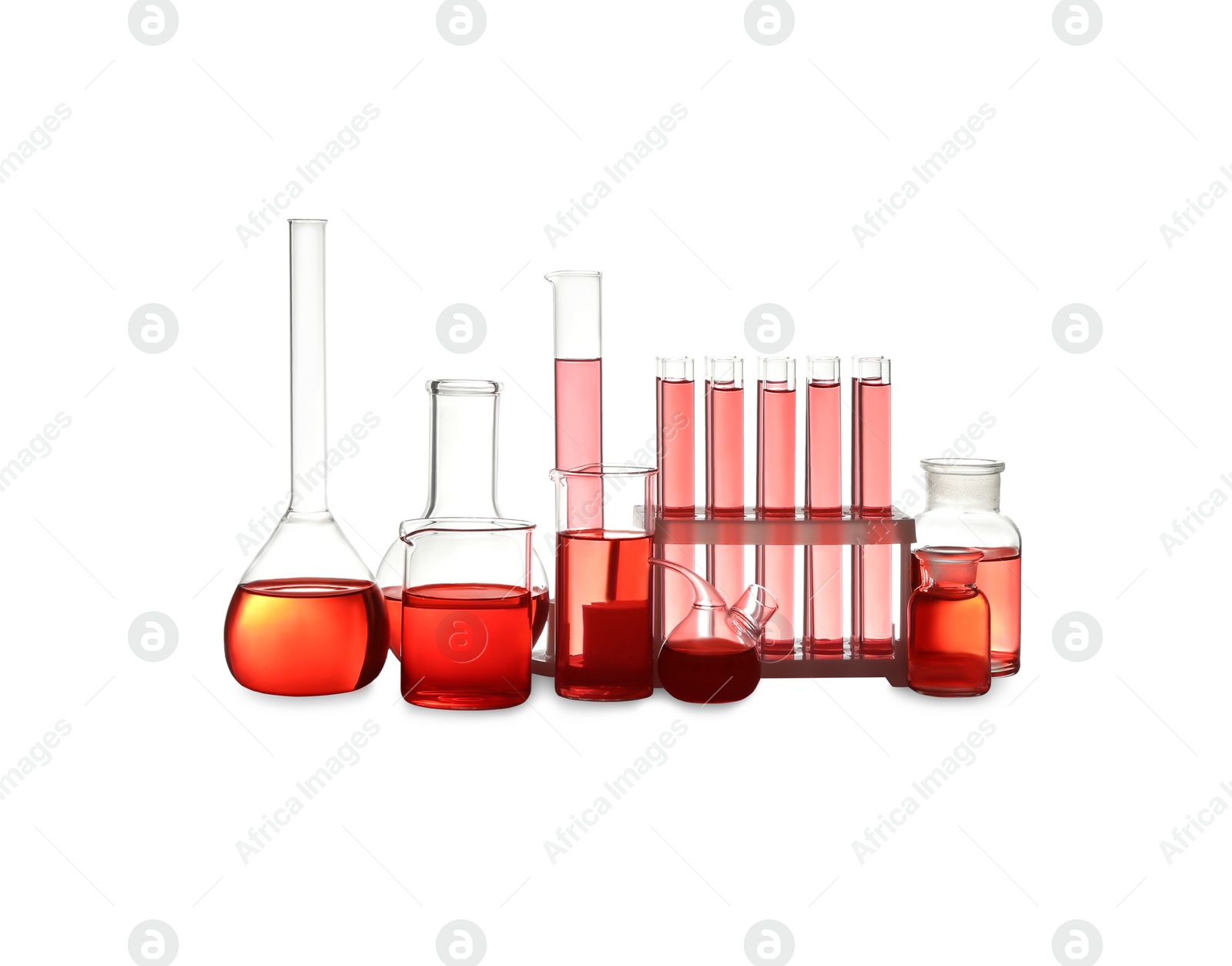 Photo of Different laboratory glassware with red liquid isolated on white