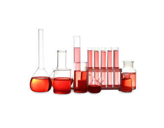 Photo of Different laboratory glassware with red liquid isolated on white