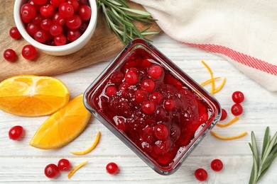 Photo of Flat lay composition with cranberry sauce and orange on white wooden table