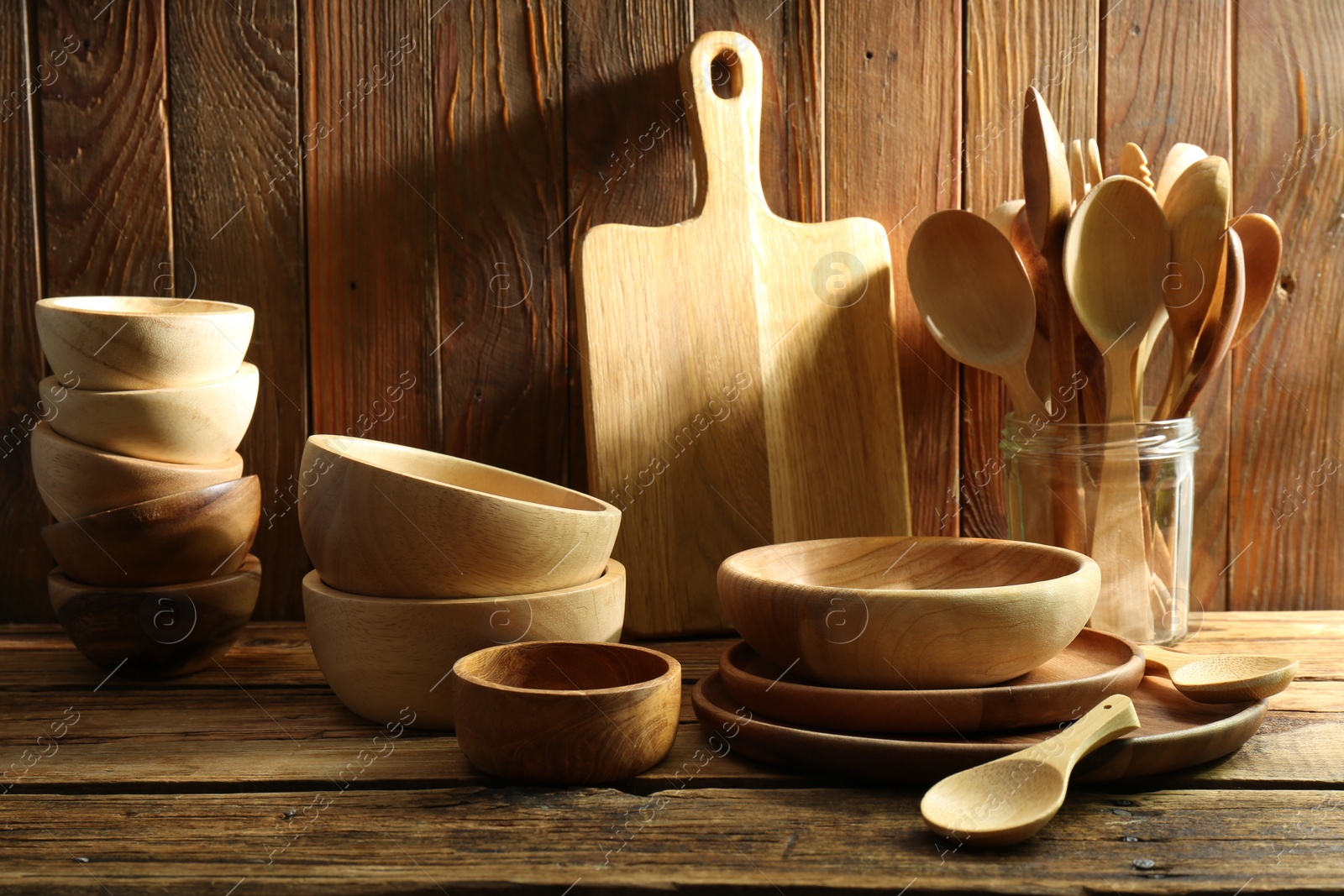 Photo of Many different wooden dishware and utensils on table